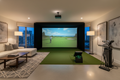 Premium indoor golf simulator setup in a luxury rental property with HD projection screen